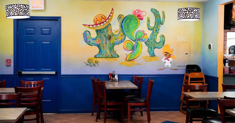 Interior, decorated wall, tables ready for guesats