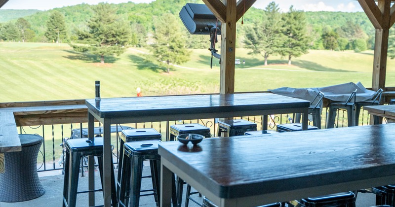 Exterior, terrace overlooking the golf course, covered seating area, high seating tables with stools