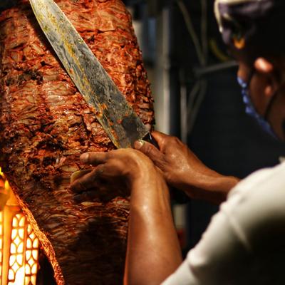 Chef cutting gyro meat.