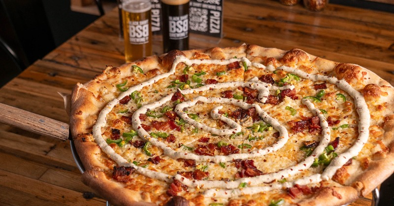 Highway to Hell pizza, with bacon bits, peppers, cheese, and sauce