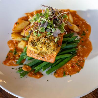 Steelhead filet served over poached potatoes and green beans.