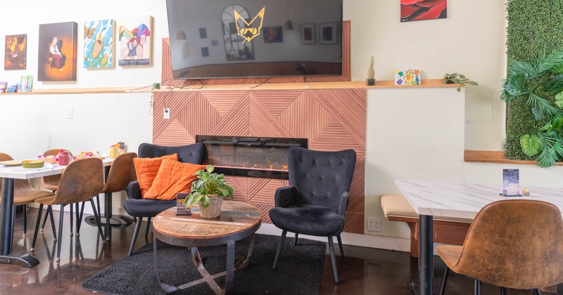 Interior, tables and chairs with TV on the wall