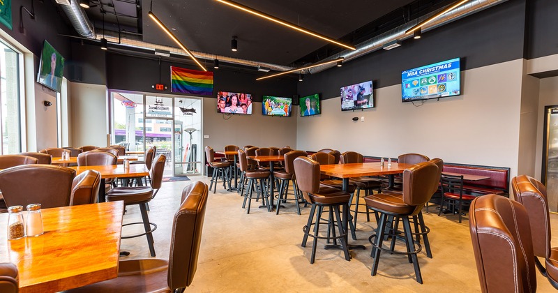 Interior, seating area, TVs on the walls, Pride banner