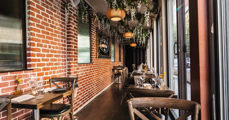 Interior, seating area, tables and chairs by the windows