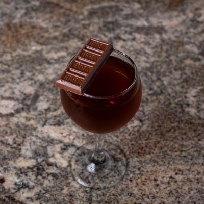 Agent of Honor, a cocktail garnished with a small chocolate bar.