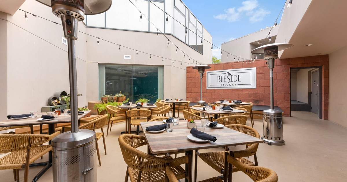 Exterior, patio, tables and chairs ready for guests, hanging lanterns decoration, space heater