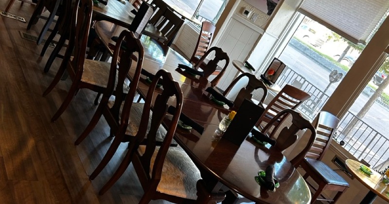Empty restaurant interior with wooden tables and chairs arranged neatly