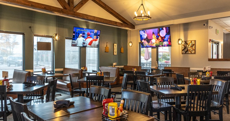 Interior, tables ready for guests, TVs on the walls