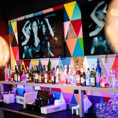 Stacked bottles behind the bar.