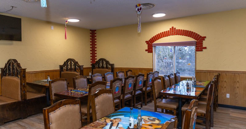 Interior of a restaurant with decorated wooden tables and chairs