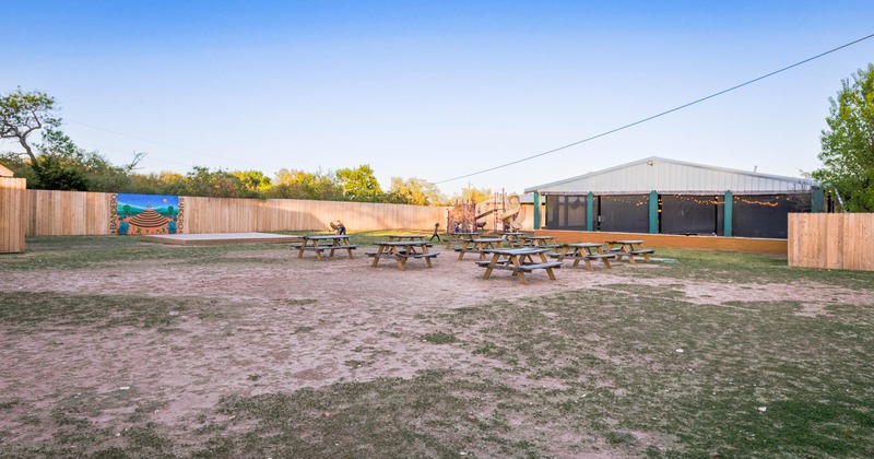 Exterior, yard with tables and bench seating, a playground for children