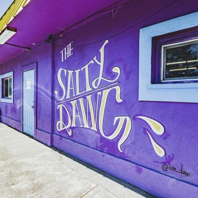 The restaurant's entrance and name written on an exterior wall.