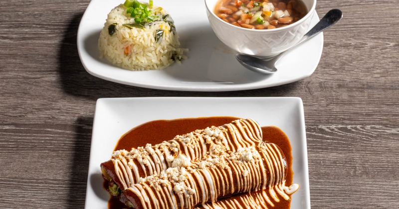 Veggie Mole Enchiladas served with sides of rice and beans