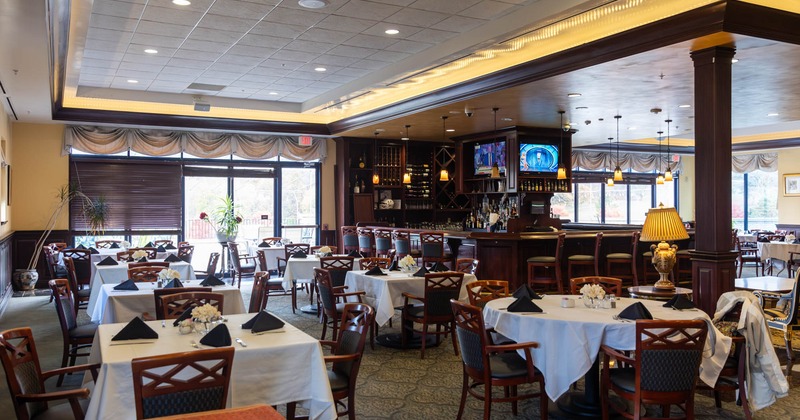 Interior, dining area, white cloth tables with wooden chairs, ready for guests