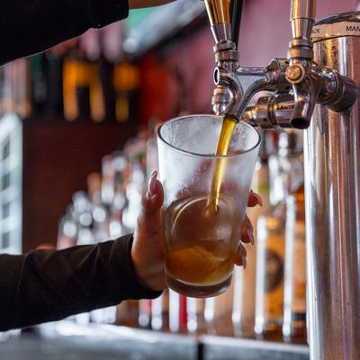 Bartender pouring beer from the tap.