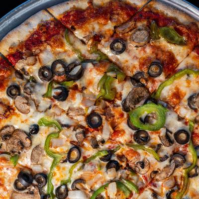 Veggie pizza with mushrooms, green peppers, olives, tomatoes, and onions.