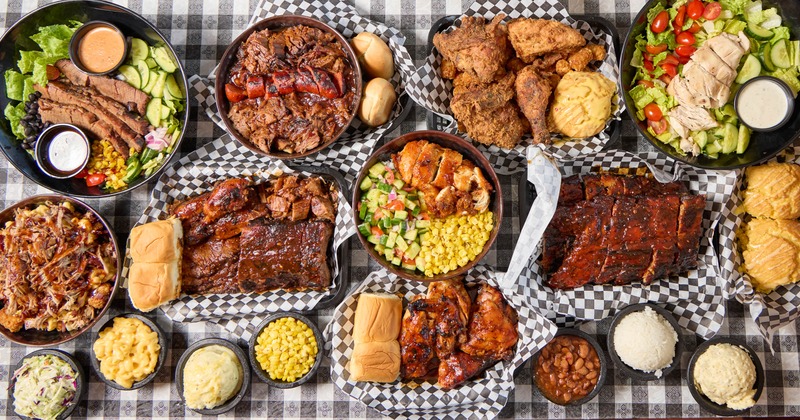 Assorted barbecue platters and sides arranged on the table