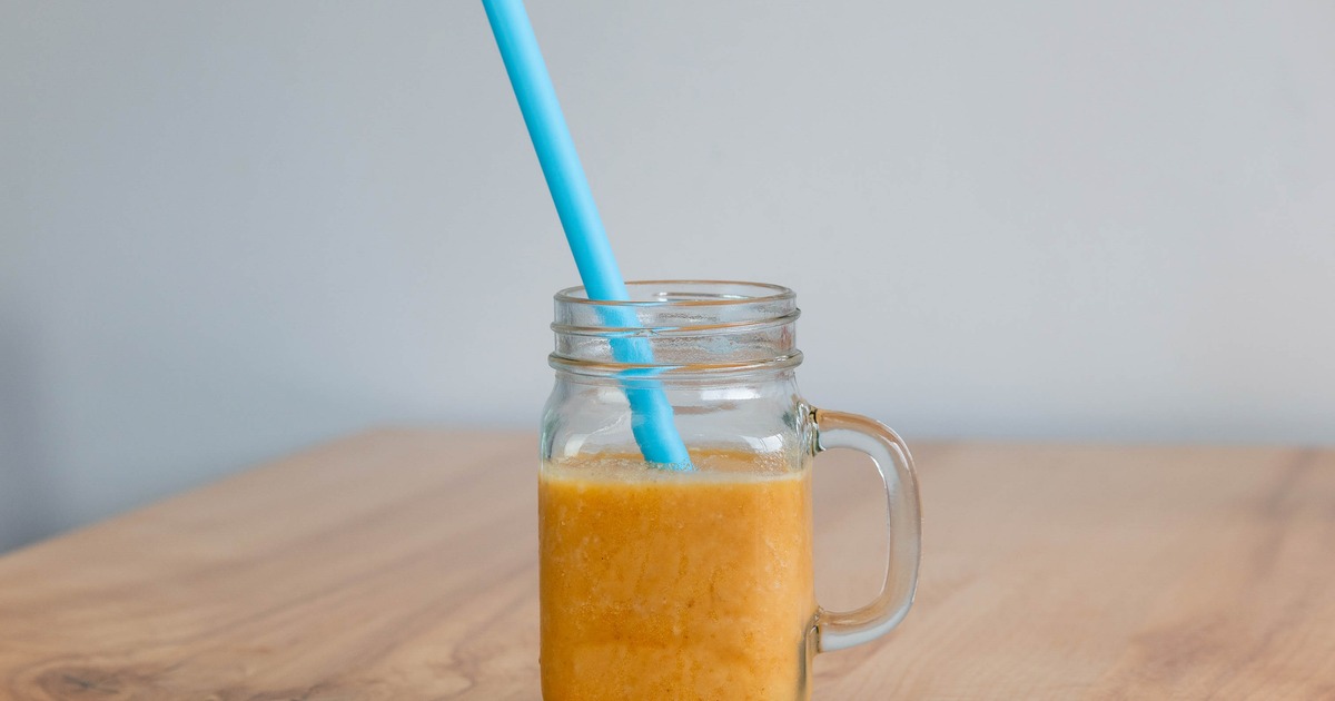 Golden Glow smoothie served in a jar with a straw