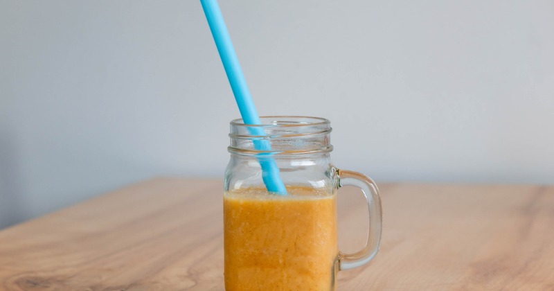 Golden Glow smoothie served in a jar with a straw