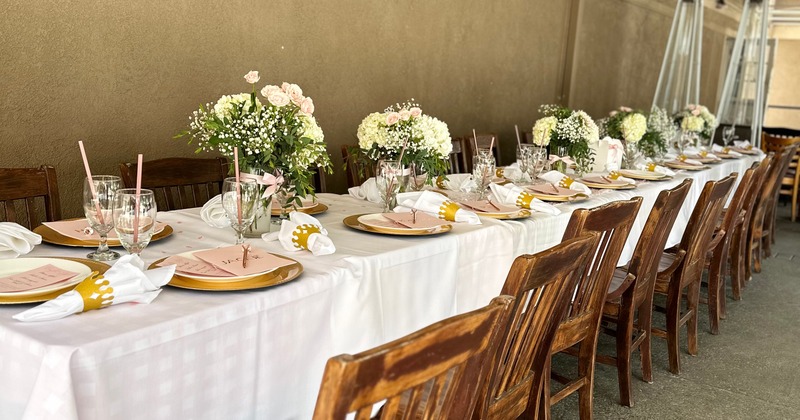 Closeup of the table for a private party with tableware and decorations