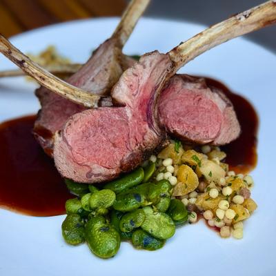 Rack of lamb with vegetables and demi glace.