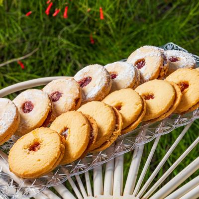Italian jam-filled sandwich cookies on a glass tray.