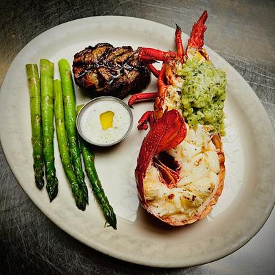Half Lobster and Filet Mignon with pesto risotto and asparagus.