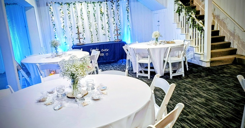 Cozy bar interior with a long wooden counter, bar stools, liquor display, TV and large windows