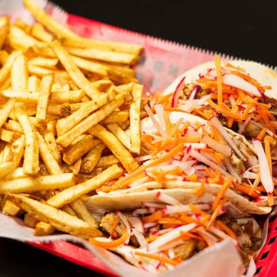 Street tacos, with chicken, Thai vinaigrette, carrots, radish, red onion, and fries.