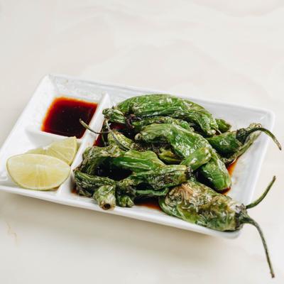Shishito peppers served with soy sauce.