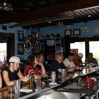 Interior, bar area with guests sitting and enjoying drinks.