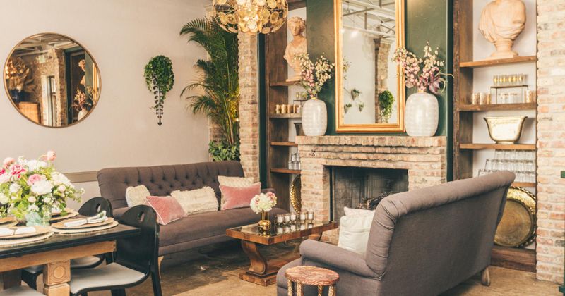 Interior, lounge seating in front of fireplace, floral decorations around the area