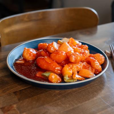 Sweet & Sour Chicken plate on a wooden table.