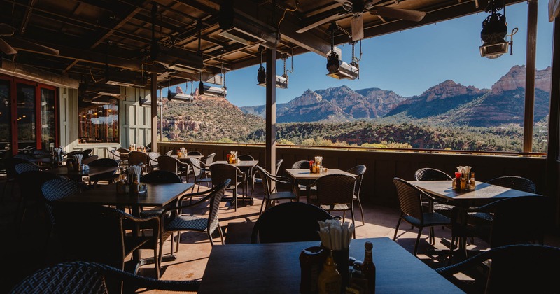 Interior, tables, chairs, a wide view of the mountains and the prairie