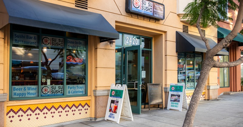 Front of restaurant, entrance, sidewalk, sign above