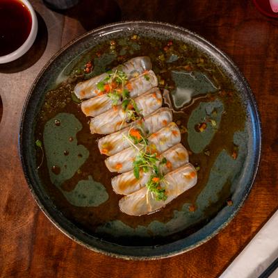 Halibut carpaccio topped with ponzu sauce, fish roe, and microgreens.