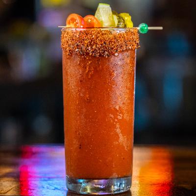 Bloody Mary with a spiced rim, cherry tomatoes, lime, and pickles.