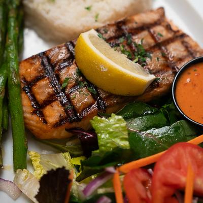 Grilled salmon fillet, with rice and salad.