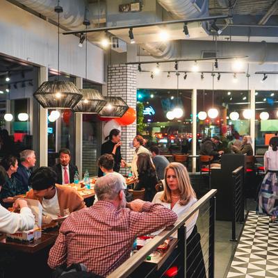 Patrons dining and socializing inside Gangnam Spice restaurant's on the opening day.