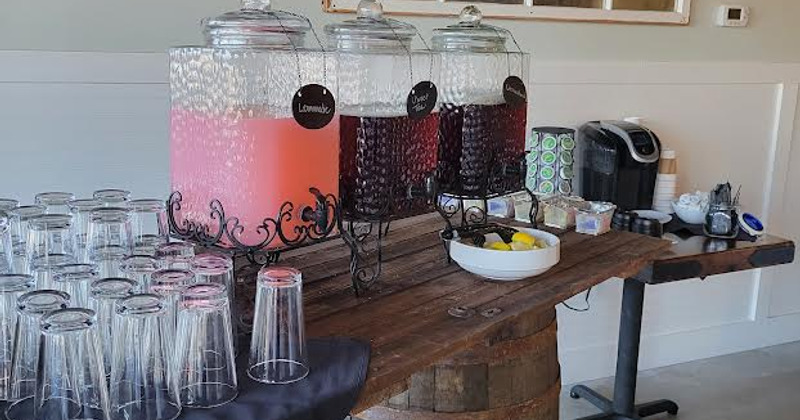 Interior, staff member at the welcome counter, guests enjoying their food and drinks in the back