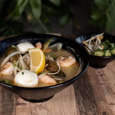Seafod Ramen featuring shrimp, mushrooms and a wedge of lemon.