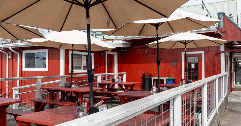 Outdoor patio seating with tables, benches and parasols