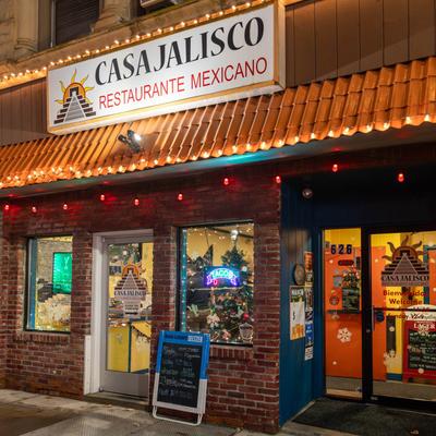 Storefront with signage, Christmas decorations, and a menu board.