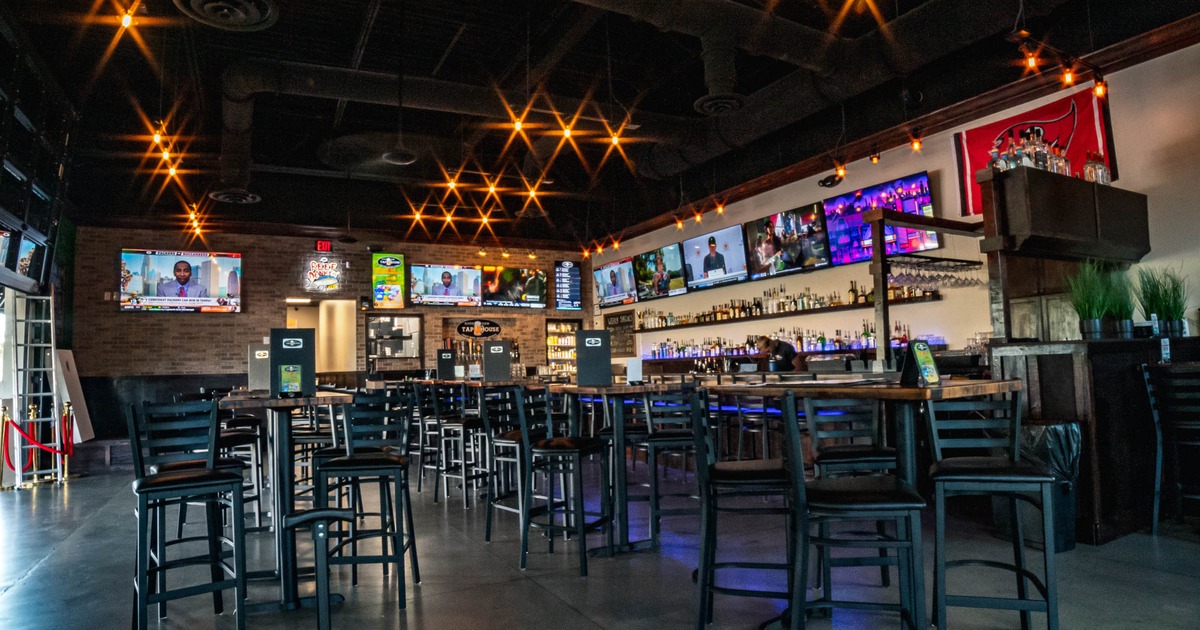 Interior, seating near bar, TVs on walls
