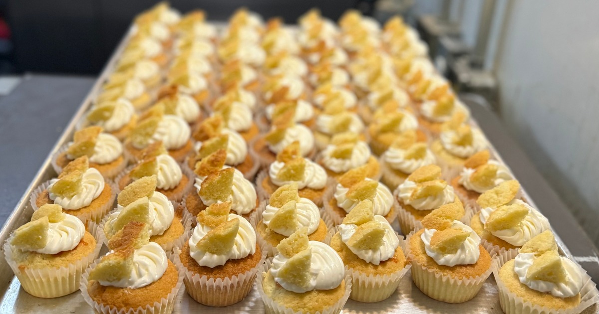 Large tray of butterfly cupcakes topped with white frosting