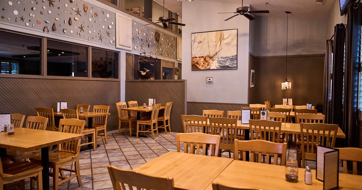 Interior, dining area, ceiling fans, sea inspired decoration, framed painting of a vintage ship