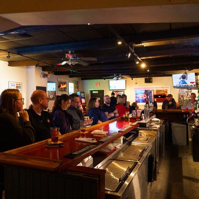 Interior, customers sitting at the bar.