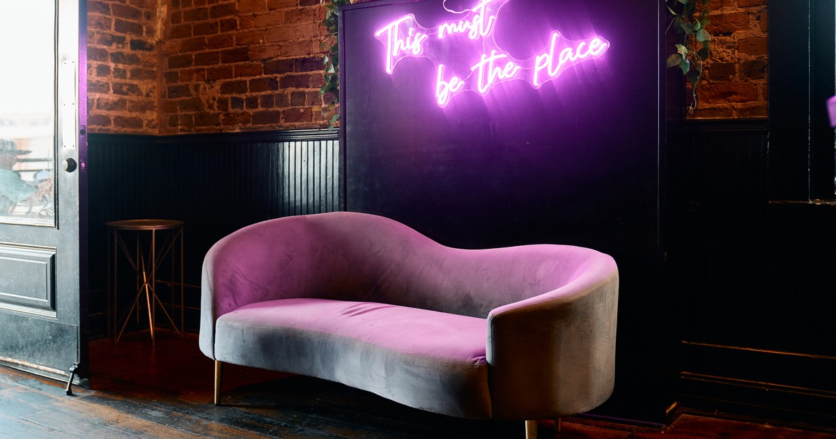 Interior, couch, light sign above