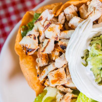 Grilled chicken tostada, with sour cream, and guacamole.
