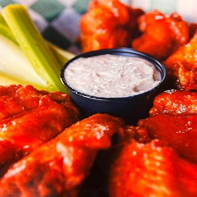 Buffalo wings with celery and blue cheese dip.